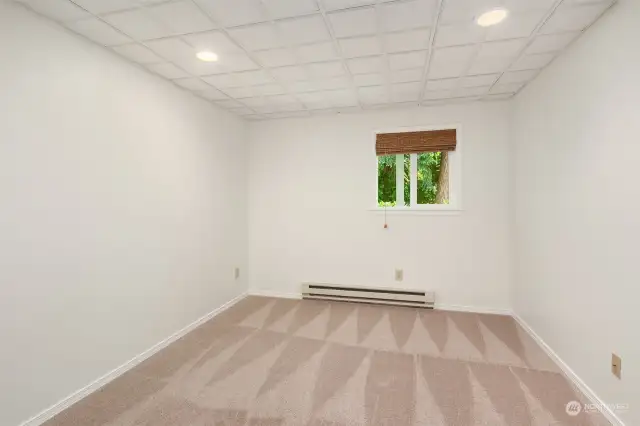 Basement bedroom with new carpet and fresh paint.