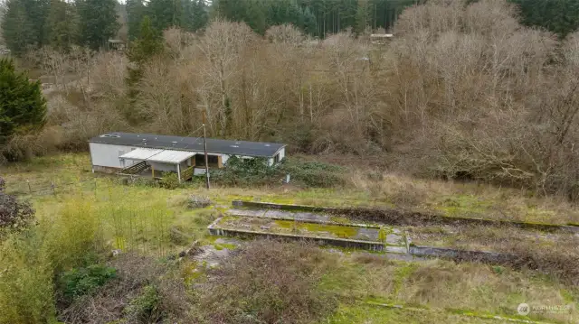 Single wide and the remnants of the foundation from an old barn