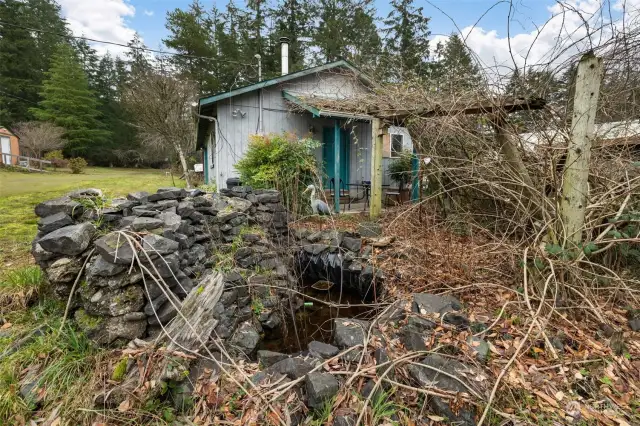 Water feature and remnants of grape arbor