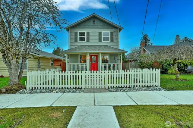 fenced front yard with covered porch.