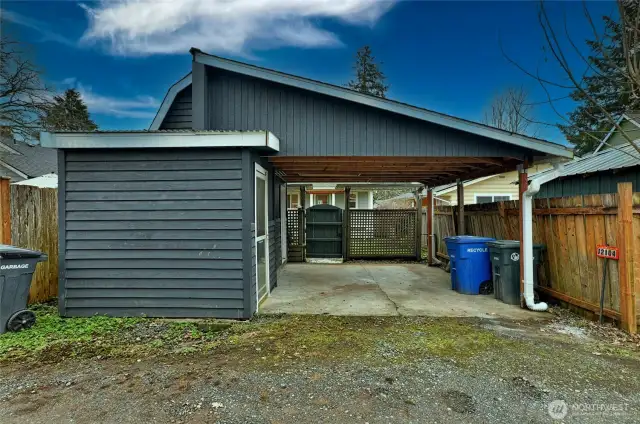 large covered carport with two storage areas.