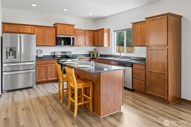 Kitchen with granite counter tops, Stainless steel appliances.