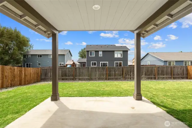 Covered patio in fully fenced back yard.