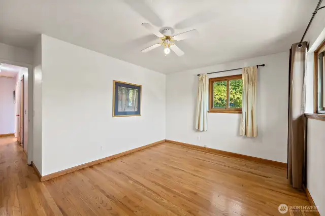 Original primary turned into 2nd bedroom at end of main hallway. Windows bring in lots of natural light and ceiling fan to keep you cool all year long.