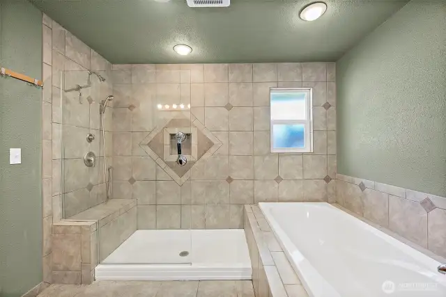 Primary en-suite bathroom complete with walk-in shower and oversized soaking tub