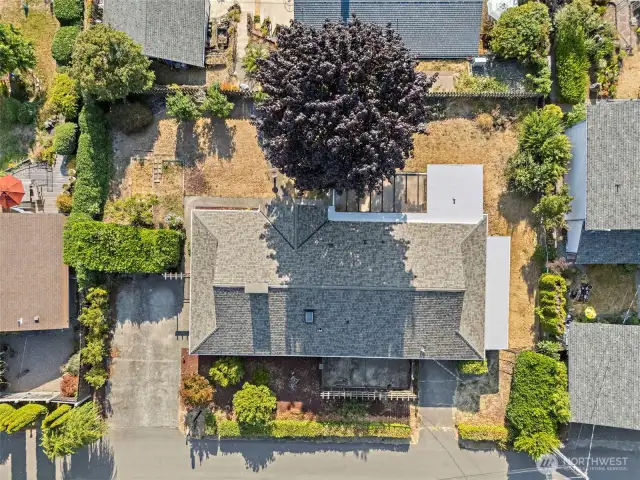 birdseye view showcase the double driveways. South driveway has room for RV parking and electric car charging capabilities . Norht driveway leads to the attached extended 1-car garage with workbench in back.