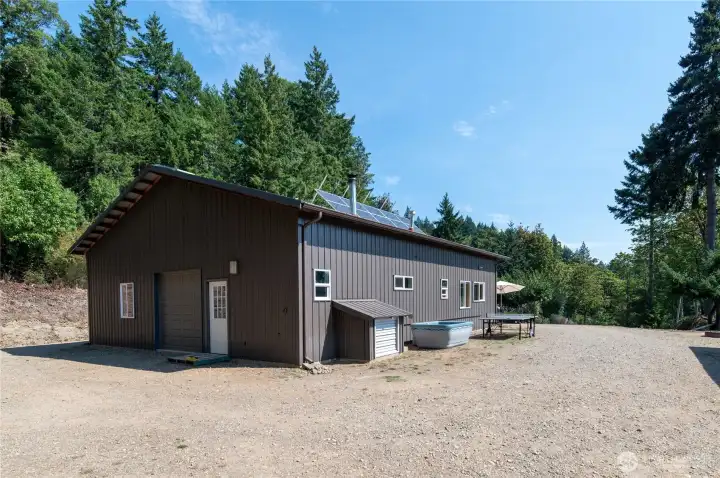 Solar panels are perfectly situated towards the south for great exposure and the little shed roof on the side of the building houses a 6000 WATT back-up generator to automatically charge the batteries as needed.