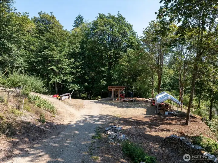 This is parcel ending in 02 and has the lower garden, the orchard, and the sawmill area. The sawmill area would make a great building site with a beautiful view of the Hood Canal and of the lower garden. The spring is also located on this parcel.