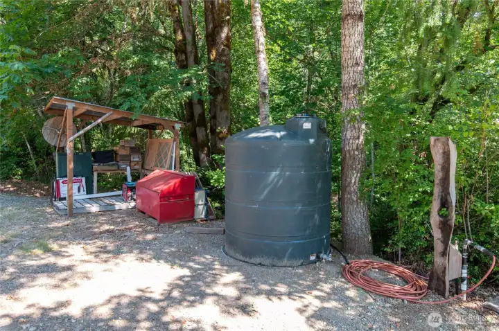 Down by the sawmill, this is the 1000 gallon tank that houses the pump that pumps to the two 3000 gallon tanks higher on the hill and then gravity feeds the rest of the property.