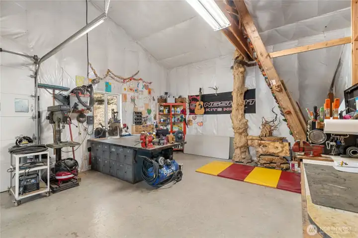 Workshop side of the garage with climbing wall and another office space