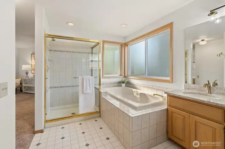 Full attached primary bathroom with separate shower, soaking tub, double vanity and toilet closet.