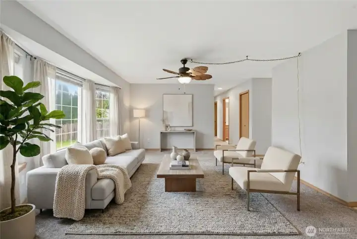 Virtually staged. Bright, welcoming living room with a comfortable, easy-flow layout.