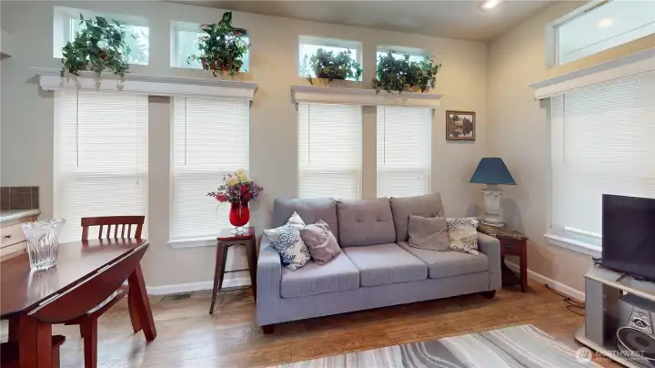 Laminate wood flooring throughout, lots of natural lighting, forced air heat and free standing air conditioning unit to keep the home cool in the summer.