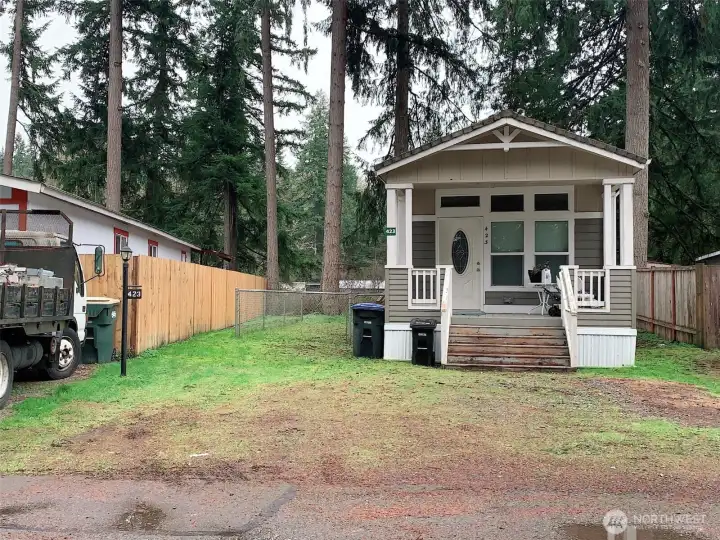 Additional view of the front of the home and side yard.