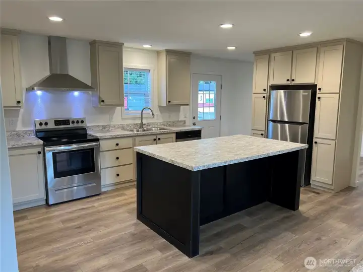 Kitchen with plenty of storage and SS appliances.