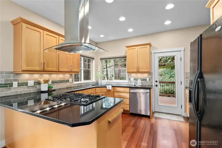 Updated kitchen with gas cooktop, stainless steel appliances, and ample cabinetry for storage.