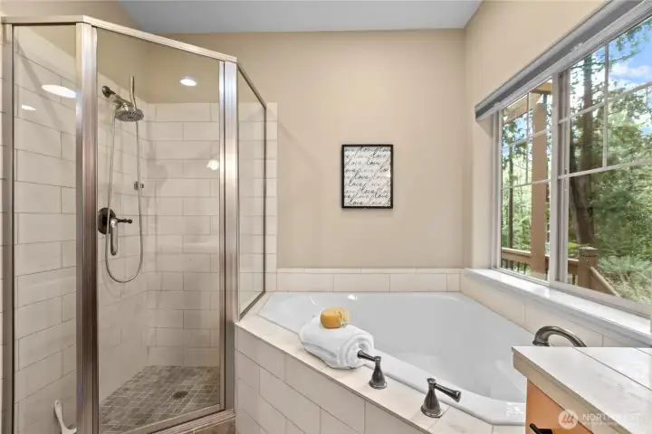 Primary bathroom layout offering both soaking tub and separate shower for daily flexibility.