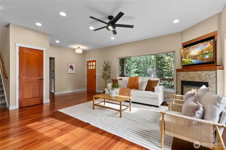 Spacious living room with recessed lighting and cozy fireplace.