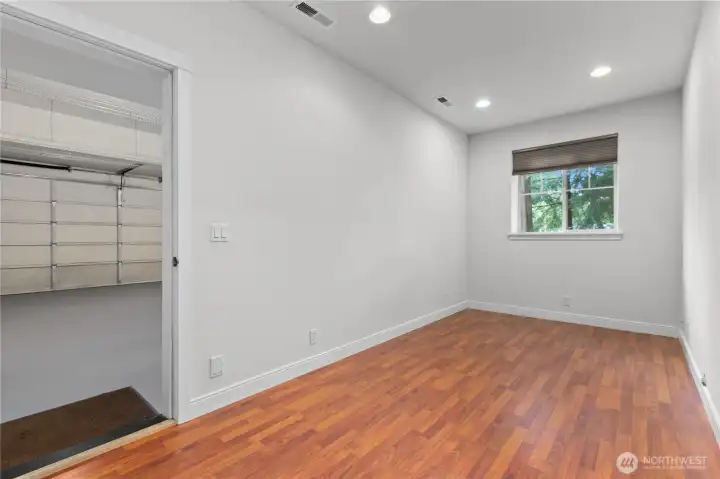 Finished lower-level room with direct access through garage, an en suite bathroom and natural light.