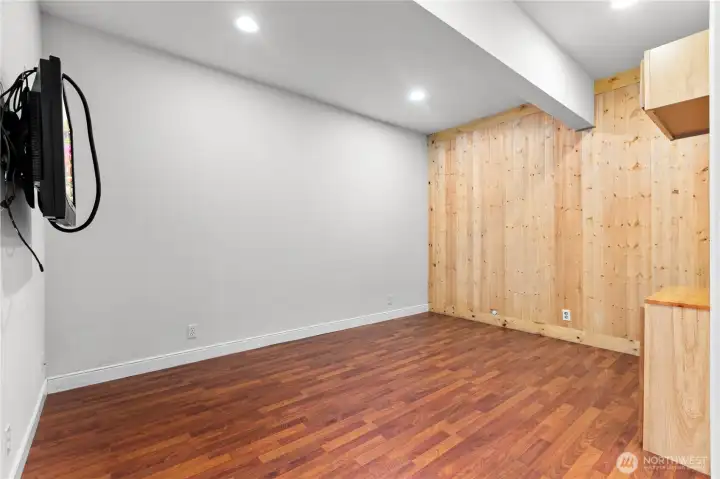 Interior bonus room with wood accent wall and flexible use potential