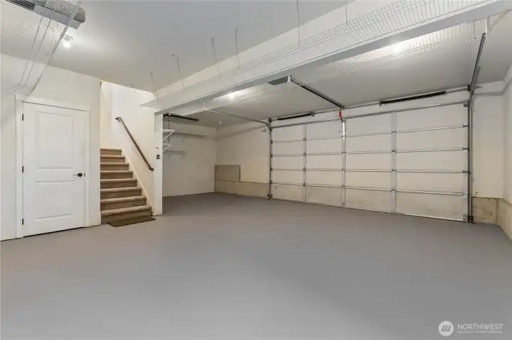 Attached garage with ample space for parking, storage, and workshop use