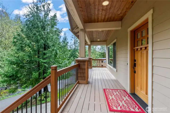 Covered front porch with wood ceiling detail, providing a welcoming entry and outdoor sitting area.