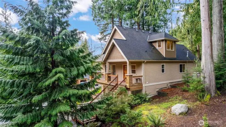 Side elevation showing home’s position on the lot with surrounding greenery and privacy.