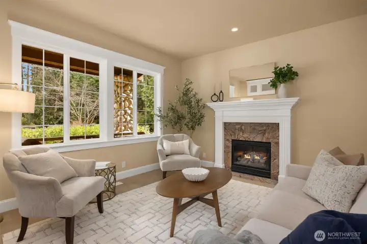 The living room with the first of three fireplaces in the home