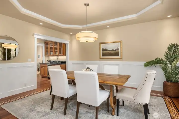 A coved ceiling, beautiful hardwood floor details and wainscoting grace the dining room.