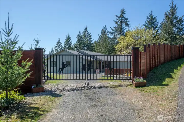 A gated entrance welcomes you into this private retreat—secure, secluded, and set back among evergreens with a long drive and plenty of room to breathe.