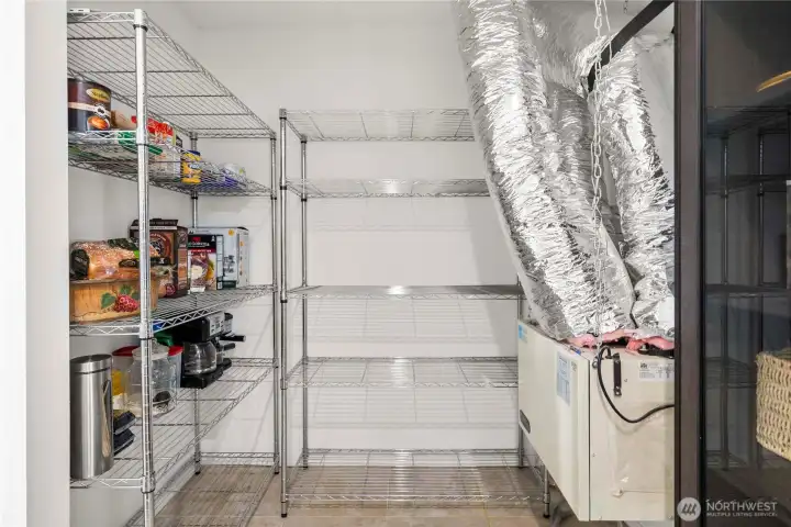Oversized walk-in pantry with ample shelving plus a dedicated air filtration/ventilation system—practical storage and smart home systems in one place.