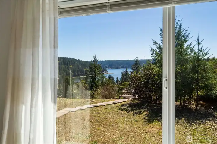 Wake up to Hood Canal views from the primary bedroom—peaceful, private, and framed by evergreens with a clear line of sight to the water.