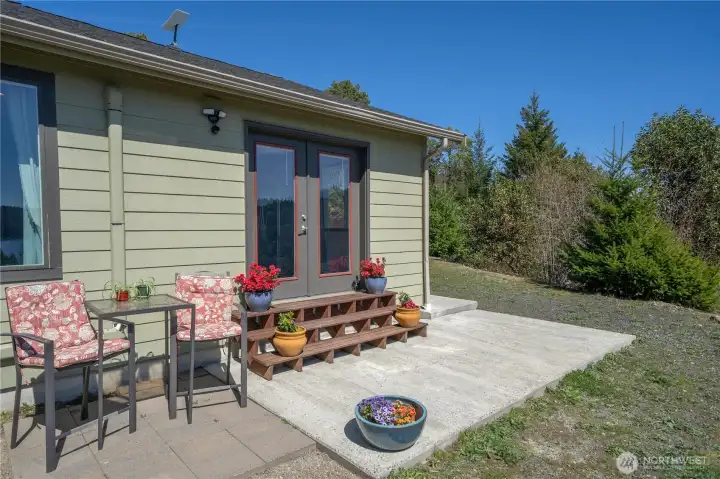 Private side patio with easy access from the home—ideal for grilling, relaxing, and enjoying the quiet, wooded setting.