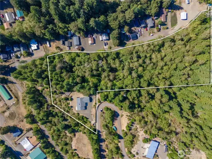 Approximate property boundaries shown—an expansive, wooded 3.8-acre parcel offering privacy and a true sense of space (lines are for illustration only; buyer to verify).