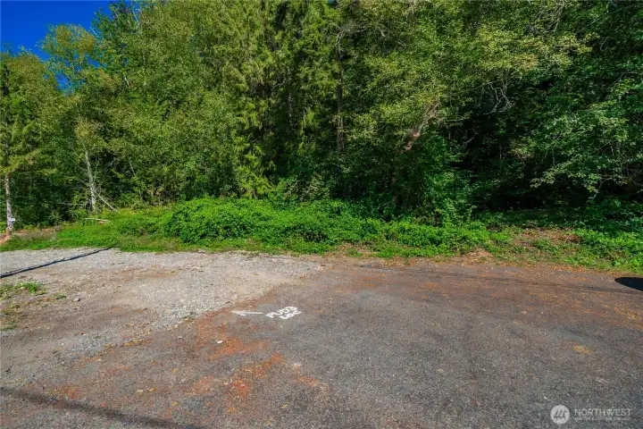 Access point from the road into the woods—there’s a usable flat area here with potential for a future garage or ADU (buyer to verify feasibility and permits).