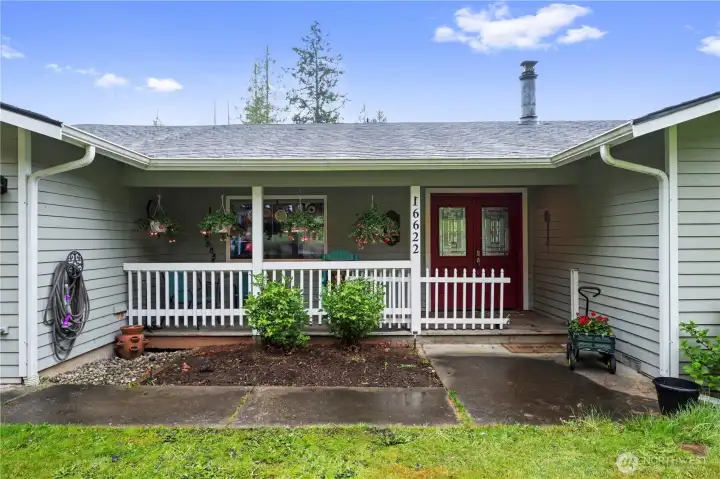 Nice covered porch with a sitting area.