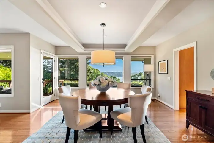 The formal dining room pairs stunning views with abundant natural light and sophisticated lighting for an elevated dining experience.