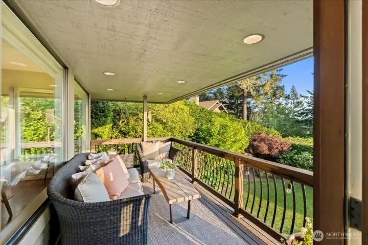 Bask in all-day sunlight on this south-facing porch overlooking a backyard filled with year-round blooms.