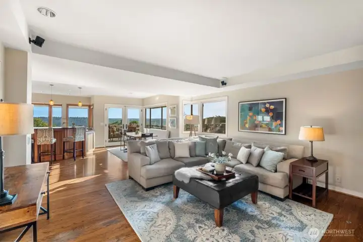 The great room brings together the family room, informal dining area, and kitchen seating in one open, light-filled space, all framed by south-facing views.