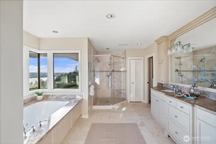 Spa-like and serene, this bathroom features double vanities, a spacious shower, and a soaking tub designed for everyday relaxation.
