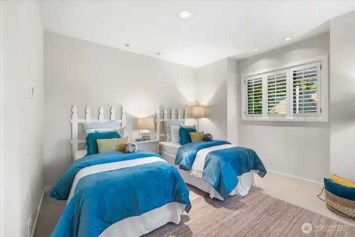 Down the hall from the primary bedroom, find a spacious bedroom with an en-suite bathroom.