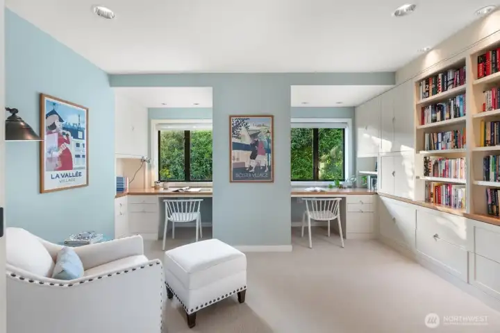 Upstairs, a dedicated office features custom built-in shelving and desks, with warm western light. This room could easily be converted into a third upstairs bedroom, as it already has a closet.