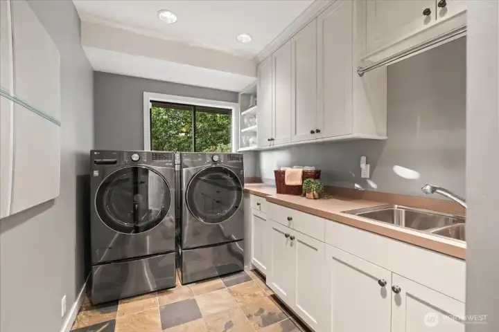The main-floor laundry room is conveniently positioned to serve all three levels of the home.
