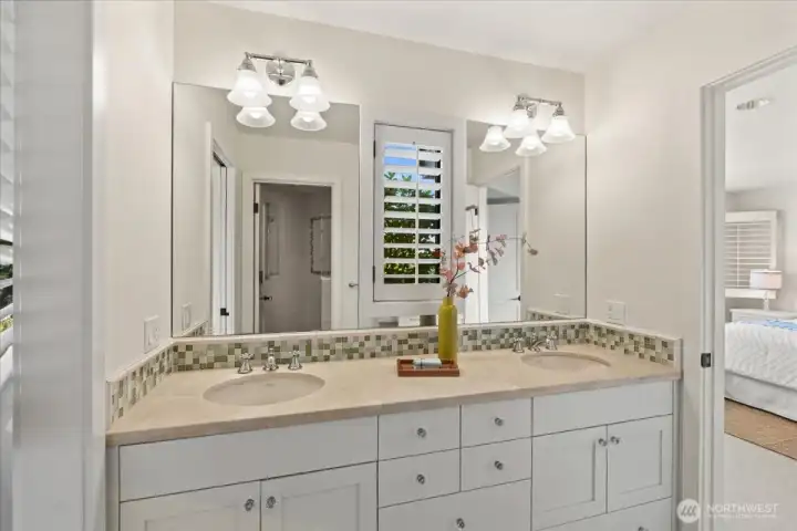 An updated Jack-and-Jill bathroom offers added convenience between two of the lower-level bedrooms.