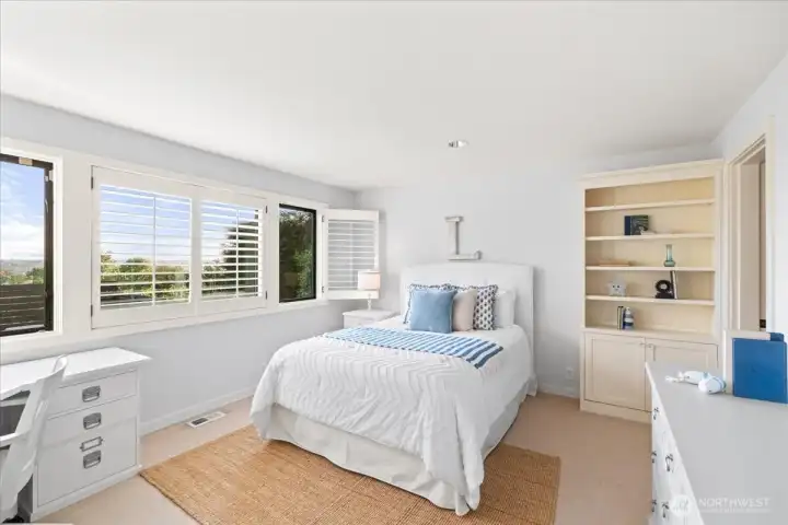 The second bedroom on the lower level, similarly light-filled, even has views of the water and Seattle.