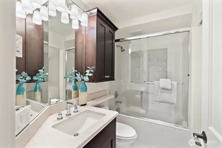 Second bathroom on the lower level, also with heated floors and updated tile and vanity.