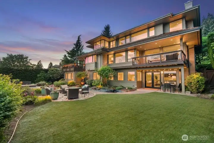 Low-maintenance turf creates a spacious area for play and entertaining just off the French doors from the lower level.