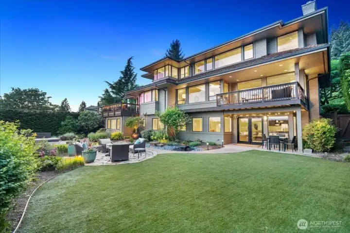 Low-maintenance turf creates a spacious area for play and entertaining just off the French doors from the lower level.