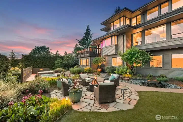 Gather around the fire pit and enjoy the elegant, manicured landscaping, professionally maintained year-round with layers of color in every direction you look.