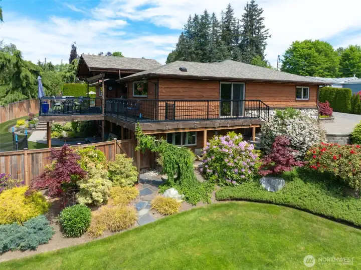 Enjoy the seamless indoor-outdoor living with a spacious deck and picturesque grounds.
